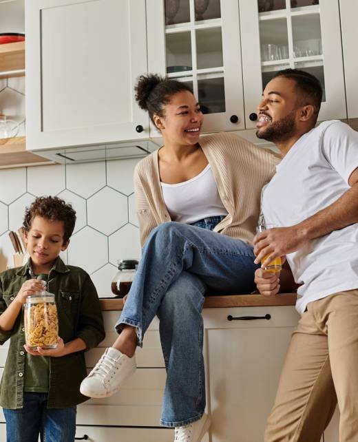 African American family bonding in a cozy kitchen.