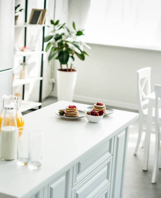 interior of modern light kitchen with pancakes on kitchen counter