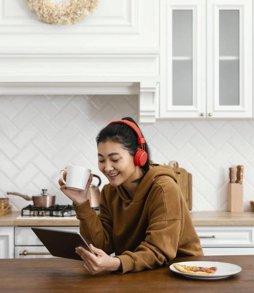 woman-wearing-headphone-looking-tablet